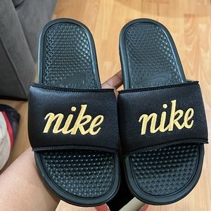 Nike women’s black and gold benassi slides